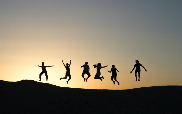 six silhouette of people jumping during sunrise by Timon Studler courtesy of Unsplash.